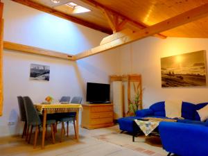 a living room with a blue couch and a table at Haus Berger in Bad Reichenhall