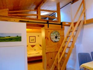 a room with a bunk bed and a ladder at Haus Berger in Bad Reichenhall