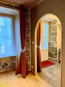 a hallway with an archway and a door in a room at Le Manoir des Haies SPA in Les Champs-Géraux +63 photos