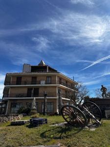 a building with twooked wheels in front of a building at Portal De La Rioja in Haro