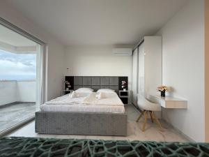 a bedroom with a large bed and a desk at Astrid Deluxe in Novalja +58 photos