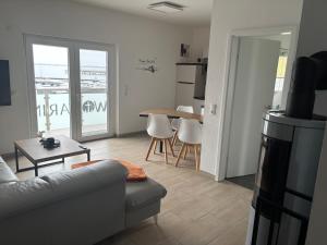 a living room with a couch and a table at Ferienwohnungen Hafenwerk in Braunsbedra +12 photos