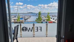 a balcony with a view of a marina at Ferienwohnungen Hafenwerk in Braunsbedra