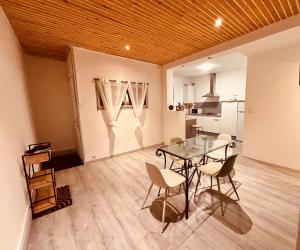 a dining room with a glass table and chairs at Votre cocon vosgien in Saint-Étienne-lès-Remiremont +36 photos