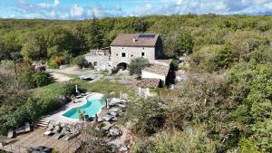 an aerial view of a house with a swimming pool at Les Dolines in Balazuc