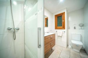 a bathroom with a shower and a toilet and a sink at Piso Marc by Sealand Villas in Port de Pollensa +18 photos