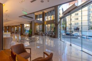 a lobby of a building with chairs and tables at Mora Hotel in Jeddah