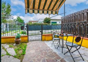 a patio with a table and chairs and a fence at Hostly G&G Home in Pisa