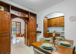 a kitchen with wooden cabinets and a wooden table at Hostly G&G Home in Pisa +31 photos