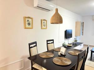 a dining room with a black table and chairs at Ribeira Sacra Ledicia in Chantada