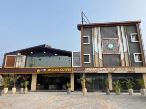 a building with a clock on the side of it at Dr Rajam's Gastro Garden in Vallam