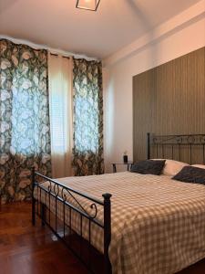 a bedroom with a large bed with a bedspread at Reginella House in Naples