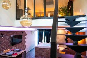 a living room with a staircase and a fireplace at Lasuite55 in Istres