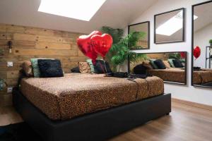 a room with a bed with a heart balloon on it at Lasuite55 in Istres +12 photos