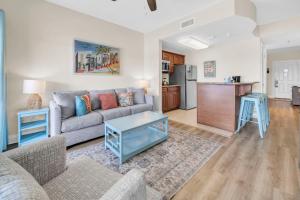 a living room with a couch and a table at Carillon Beach Inn 310 in Panama City Beach