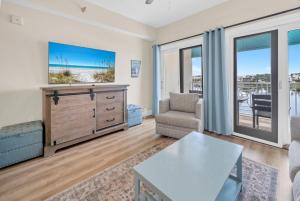 a living room with a view of the ocean at Carillon Beach Inn 310 in Panama City Beach