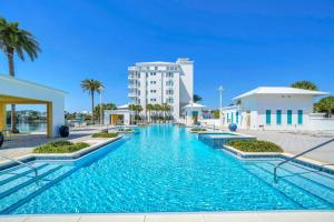 a swimming pool in front of a building at Carillon Beach Inn 310 in Panama City Beach