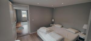 a bedroom with a bed with white sheets and pillows at Snäckstrand Guesthouse in Färjestaden