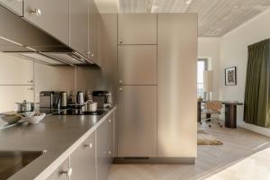 a kitchen with white cabinets and a counter top at Makerstoren Short stay serviced apartments for 28 to 180 days in Amsterdam