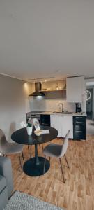 a kitchen with a table and chairs in a room at Snäckstrand Guesthouse in Färjestaden
