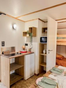 a small kitchen with a counter and a refrigerator at Camping Le Platin - La Redoute in Rivedoux-Plage +30 photos