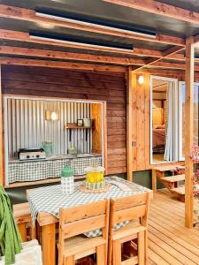a dining room with a table and chairs at Camping Le Platin - La Redoute in Rivedoux-Plage