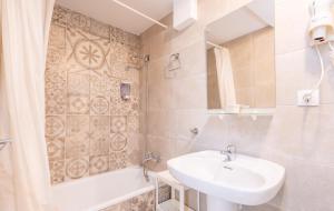 a bathroom with a sink and a bath tub and a sink at Hotel Antares in Cala d´Or +19 photos