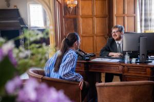 two people sitting at a desk in front of a computer at Rutland Hall Hotel & Spa in Oakham +37 photos