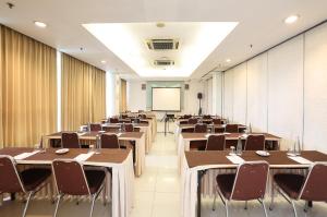 a conference room with tables and chairs and a whiteboard at Amaris Hotel Bekasi Barat in Bekasi