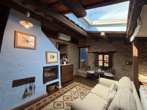 a living room with a couch and a fireplace at Mas Cal Sastre in Sant Hilari Sacalm