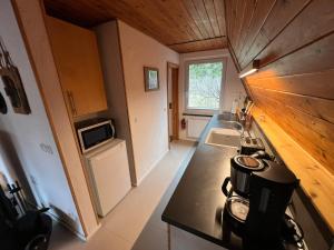 a small kitchen with a stove and a sink at Ostseeferienhaus Finni in Ribnitz-Damgarten +16 photos