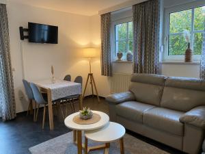 a living room with a couch and a table at Gästehaus Frankenwaldhof in Bad Steben