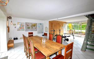 a dining room with a wooden table and chairs at Authentique Maison Piscine in La Cassaigne +22 photos