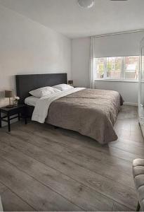 a bedroom with a large bed and a window at The Residence Enschede in Enschede