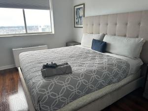 a bedroom with a large bed with a bag on it at Prime Location 1BR Near Top Attractions & Stadiums with Free Parking-1204 in Atlanta