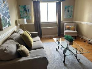 a living room with a couch and a glass table at Prime Location 1BR Near Top Attractions & Stadiums with Free Parking-1204 in Atlanta