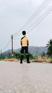 a man standing in the middle of the road at Wai zin in Sara Buri