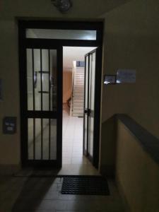 an open door to a hallway with a door at Catherine Suite in SantʼEufemia Lamezia