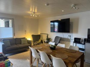 a living room with a table and chairs and a couch at Ferienhaus Lenartz in Kliding