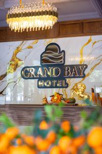 a sign for a grand bay hotel on a wall at Grand Bay Hotel - Grand World Phu Quoc in Phú Quốc +78 photos