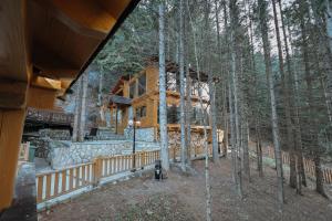 a log home in the woods with a fire hydrant in front at Seraphine Chalet in Peje