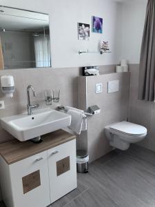 a bathroom with a sink and a toilet at Haus Plankensteiner in Kaunertal +26 photos