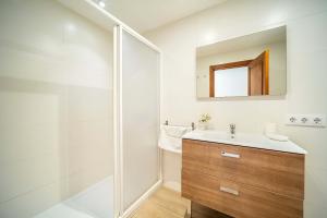 a bathroom with a shower and a sink and a mirror at Piso Marina by Sealand Villas in Port de Pollensa +20 photos