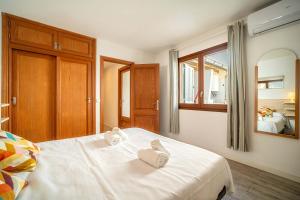 a bedroom with a bed with two towels on it at Piso Marina by Sealand Villas in Port de Pollensa