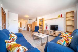 a living room with a blue couch and a table at Piso Marina by Sealand Villas in Port de Pollensa