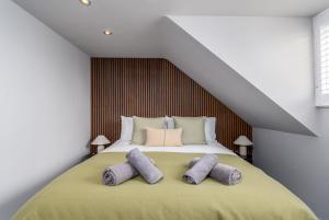 a bedroom with a bed with two pillows on it at The Castle Suite 24h Gym Free Parking in Kenilworth