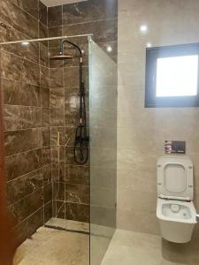 a bathroom with a shower and a toilet at Villa mima in Midoun +16 photos