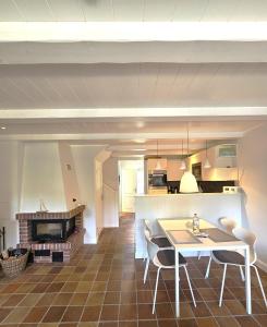 a kitchen and dining room with a table and chairs at Pastoratshof - Haus 6 in Wrixum