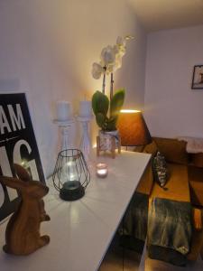 a living room with a table with flowers and candles at PIK-Kwatery in Morąg +21 photos