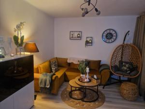 a living room with a couch and a table at PIK-Kwatery in Morąg